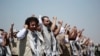 FILE - In this Oct. 16, 2020, file photo, Yemeni prisoners chant slogans during their arrival after being released by the Saudi-led coalition at the airport in Sanaa, Yemen.
