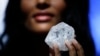 A model displays a large diamond at Sotheby's in New York, May 4, 2016. A 3-billion-year-old diamond the size of a tennis ball — the largest discovered in over a century — could sell for more than $70 million, auctioneer Sotheby's said Wednesday.