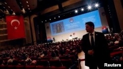 A security personnel stands guard as Turkey's Prime Minister and presidential candidate Tayyip Erdogan addresses the audience during a meeting to launch his election campaign, in Istanbul, July 11, 2014.