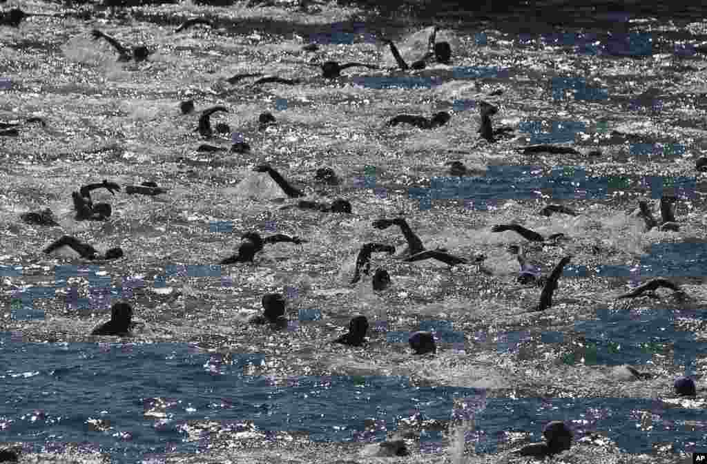 Athletes swim from Asia to Europe in the Bosporus strait during the Bosporus Cross-Continental Swimming Race in Istanbul, Turkey.
