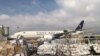 FILE - Staff members of King Salman Humanitarian Aid and Relief Center unload humanitarian aid at Beirut International Airport following a blast in Lebanon, Aug. 7, 2020. Analysts say Lebanon can no longer count on aid from wealthy Gulf Arab states.