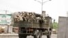 FILE - Soldiers are seen on a truck along a road in Maiduguri in Borno State, Nigeria, May 14, 2015. The Nigerian army reopened a major road Wednesday, linking towns such as Maiduguri and Diffa.