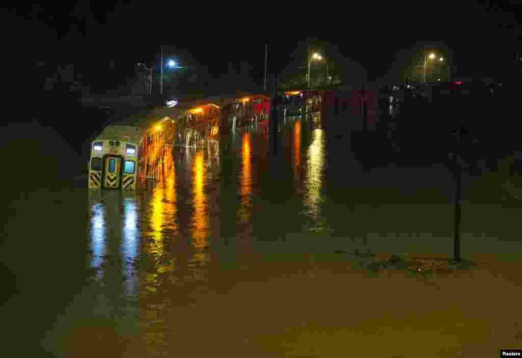 A Go Train, a commuter train, with passengers waiting to be rescued inside, is stuck in flood waters during a heavy rainstorm in Toronto, Canada, July 8, 2013. 