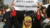 A Palestinian, who had fled the fighting in Syria, carries a sign during a protest in front of the Offices of the UNHCR in Beirut, Lebanon, Dec. 4, 2014.