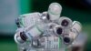 FILE - Empty vials of China's Sinopharm vaccine sit in a cup, Feb. 10, 2021. 