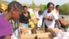 A volunteer in an "I Bleed Baltimore" T-shirt helps pack items at a pop-up food pantry in Baltimore, Maryland, April 30, 2015.