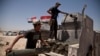 Iraqi counterterrorism forces load a Humvee with rockets to take to a front line position in their fight to oust Islamic State militants from Fallujah, Iraq, June 7, 2016.
