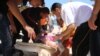 Injured people are treated after gunmen opened fire at beach near the Imperial Marhaba hotel in Sousse, Tunisia, June 26, 2015. 