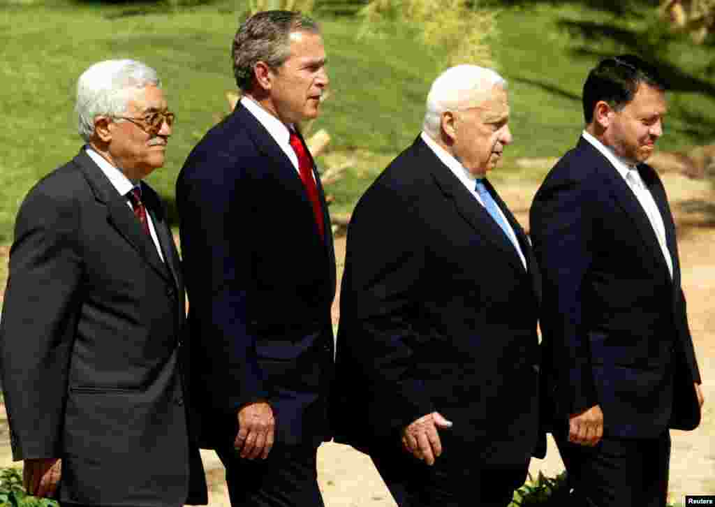 Palestinian Prime Minister Mahmoud Abbas, U.S. President George W. Bush, Israel's Prime Minister Ariel Sharon and Jordan's King Abdullah walk to the podium for their final statement at the end of a summit in Aqaba, June 4, 2003.