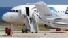 A man believed to be the hijacker of the EgyptAir Airbus A-320, which was diverted to Cyprus, leaves the plane before surrendering to security forces after a six-hour standoff on the tarmac at Larnaca airport's largely disused old terminal on March 29, 20