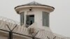 FILE - A guard stands in a watchtower in Kashgar, Xinjiang Uyghur Autonomous Region, China, May 3, 2021. 
