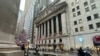 FILE - A scooter passes the New York Stock Exchange in New York's Financial District, Dec. 17, 2024.