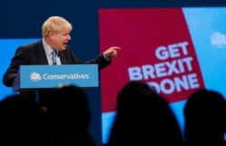 Britain's Prime Minister Boris Johnson delivers a speech at the Conservative Party Conference in Manchester, England, Oct. 2, 2019.