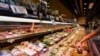 A customer shops at a supermarket for sushi and sashimi, some of which are labeled as from Japan, in Hong Kong, on Aug. 24, 2023.