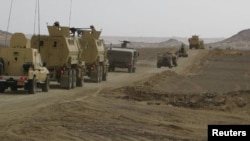 FILE - Egyptian Army vehicles are seen in the troubled northern part of the Sinai Peninsula during a launch of a major assault against militants, in Al Arish, Egypt, in this undated handout picture made available by the Ministry of Defense, March 4, 2018.
