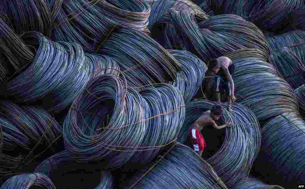 Children looks for metal scraps at a pier in Manila, the Philippines.