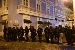 Police units protect the area near the executive mansion from protesters demanding the resignation of Governor Ricardo Rossello, in San Juan, Puerto Rico, July 15, 2019.