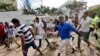 Somali men carry away the body of a civilian who was killed in a militant attack on a restaurant in Mogadishu, Somalia Thursday, June 15, 2017. 