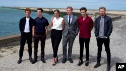 Left to right, Tom Glynn-Carney, Fionn Whitehead, Emma Thomas, director Christopher Nolan, Harry Styles and Jack Lowden pose for photographers upon arrival at the premiere of the movie "Dunkirk," in Dunkirk, northern France, July 16, 2017. The film, direc