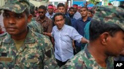 FILE - Maldivian President Abdullah Yameen Abdul Gayoom, center, surrounded by his body guards arrives to address his supporters in Male, Maldives, Feb. 3, 2018.