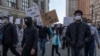 FILE - People march during a ‘Stop Asian Hate’ rally in downtown Detroit, Michigan on March 27,2021, as part of a nation wide protest in solidarity against hate crimes directed towards Asian Americans.