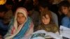 FILE - Pakistani children study in a makeshift school after fleeing from the neighboring Khyber tribal region due to fighting between security forces and militants, in Peshawar, Pakistan.