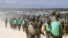 FILE - African Union Mission in Somalia (AMISOM) peacekeepers from Burundi patrol after fighting between insurgents and government soldiers erupted on the outskirts of Mogadishu, May 22, 2012.