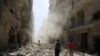 Men inspect the damage after an airstrike on the rebel held al-Qaterji neighbourhood of Aleppo, Syria, Sept. 25, 2016. 